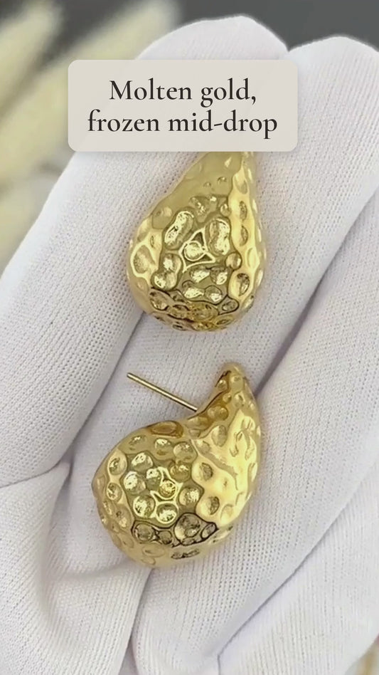 Qatra hammered gold teardrop hoop earrings catching the light up close